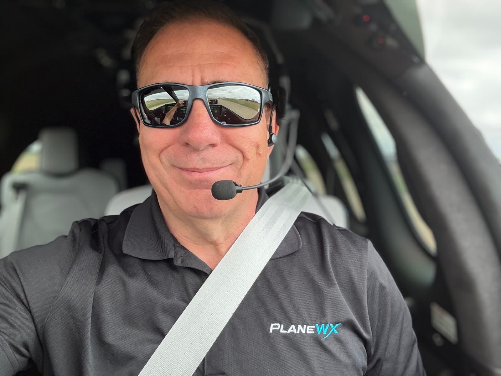 Don Medine in a PlaneWX polo in the cockpit