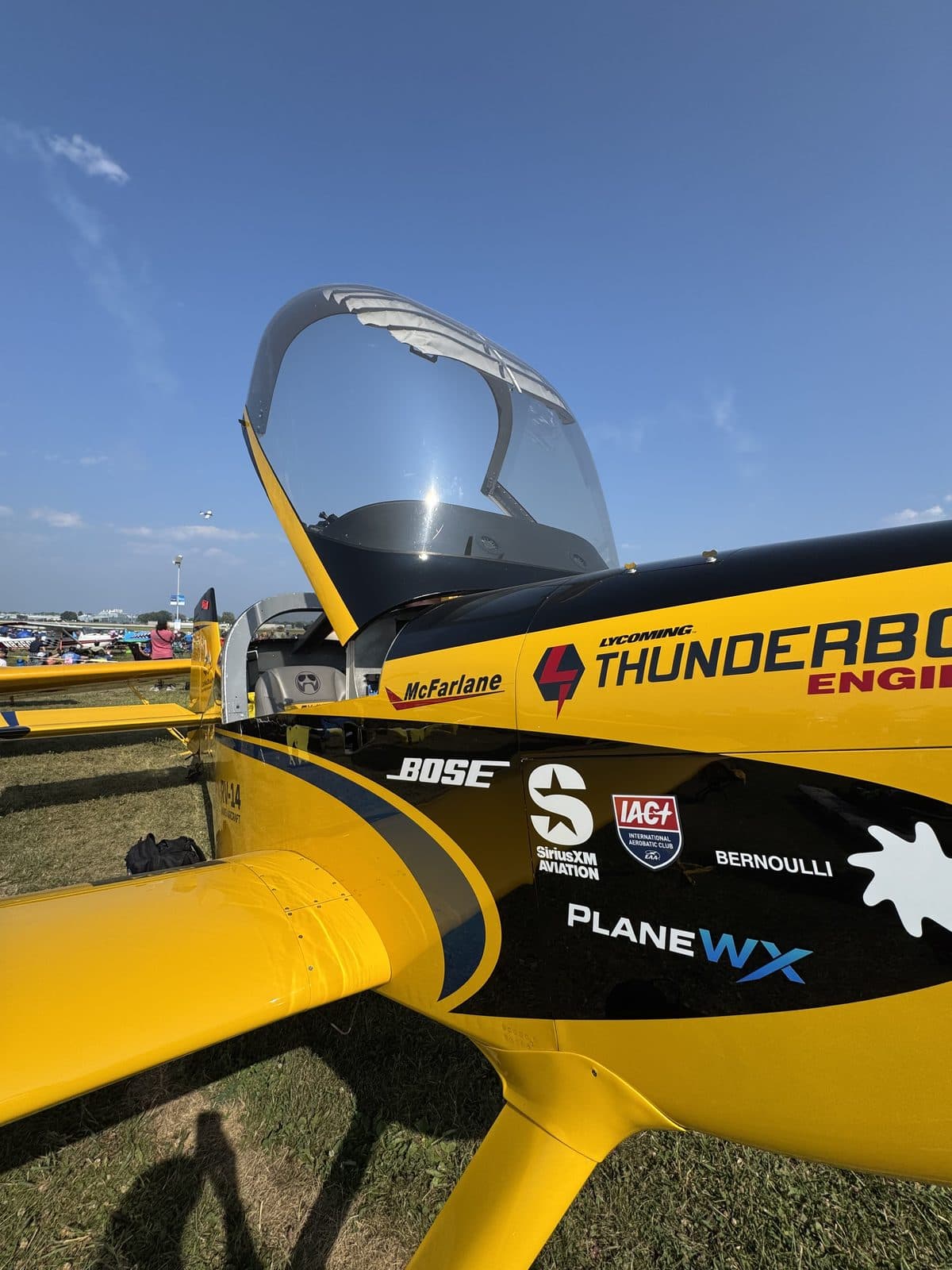 Yellow Flight Chops RV-14 at Oshkosh with the PlaneWX wordmark on the fuselage